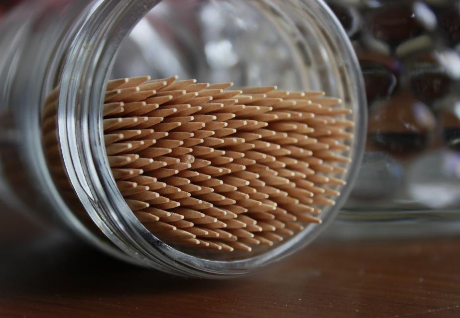 A glass storage jar of dry food tipped on its side